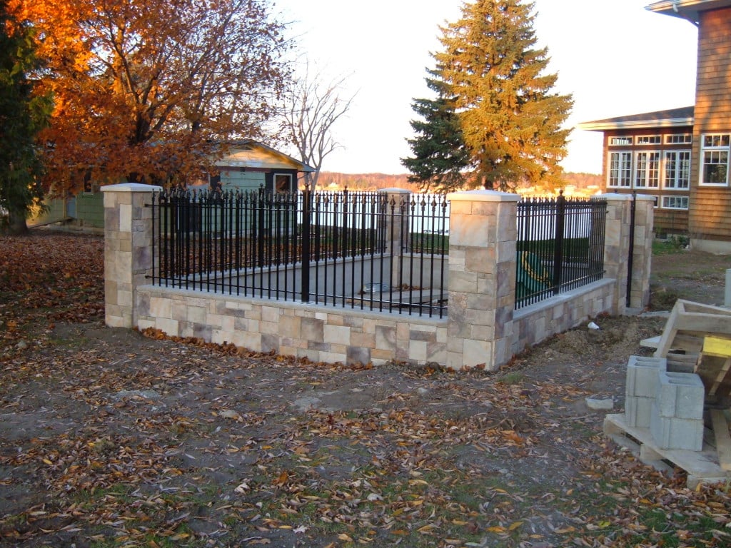 Our Iron Fence Used in Conjunction with a Stone Knee Wall and Columns to Make a Play Area for the Grandkids