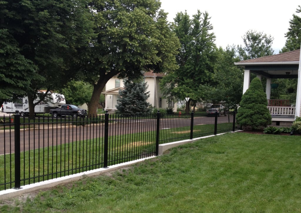 Iron Fence Mounted on a Knee Wall and Stepped for Grade Using Different Heights of Fence