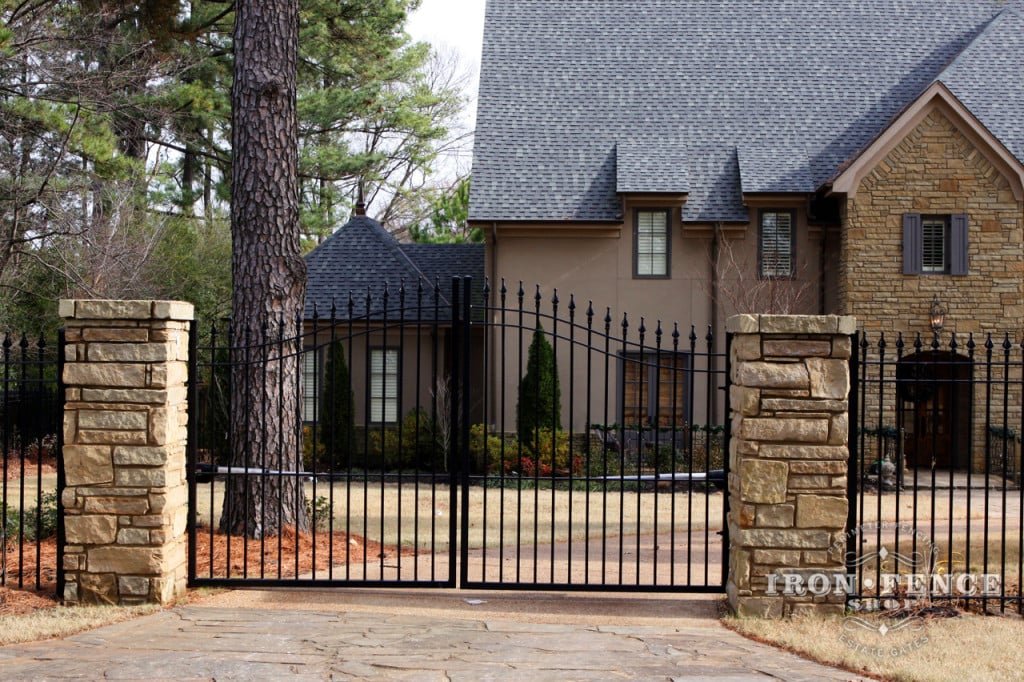 Iron Gate Mounted on Steel Posts Hidden Behind the Stone Columns