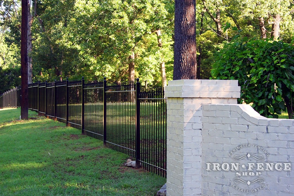 Iron fence panels can follow grade by 'stair-stepping', but it requires a little additional attention during planning and installation