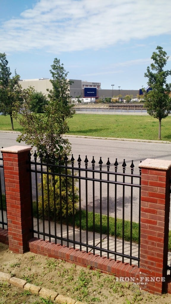 The aluminum fence and brick work make for an attractive barrier while not blocking the view from the yard