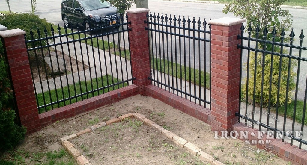 The combination of aluminum fence and brick not only create a barrier, but make for a nice courtyard garden