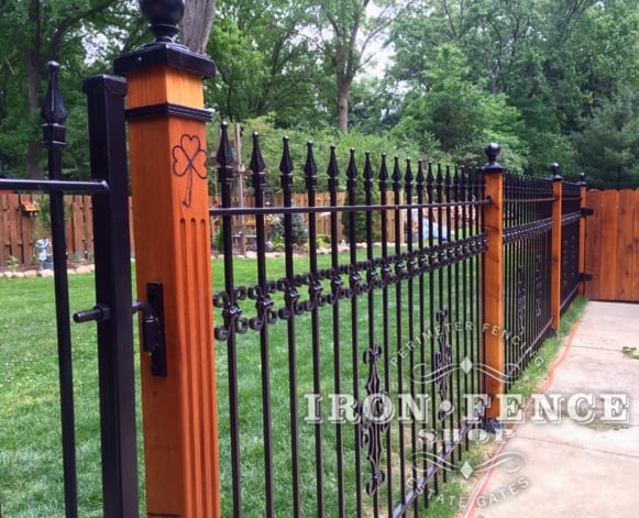 Wood Posts Combined with  Wrought Iron Fence Make for a Stunning Custom Look
