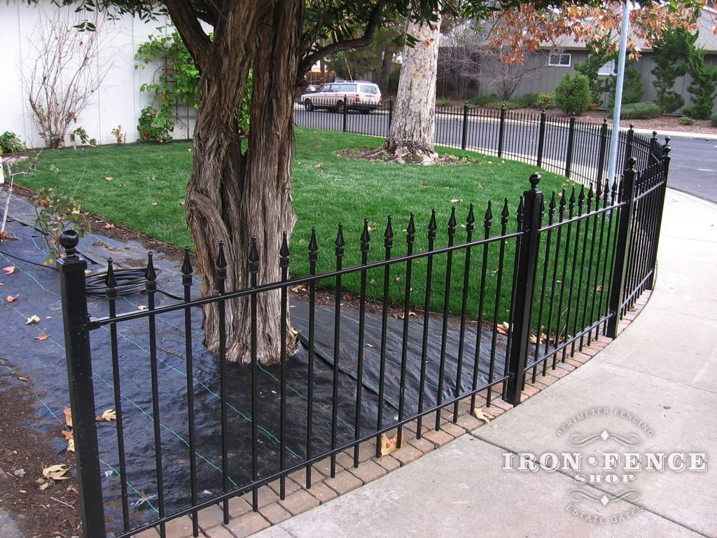 Iron Fence Panels Installed Along a Curved Sidewalk