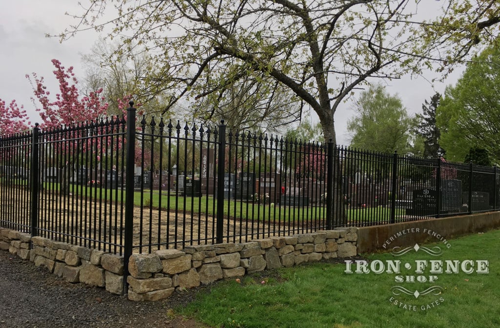 Wrought Iron Fence Surrounding a Cemetery un Conjunction with a Stone Knee Wall