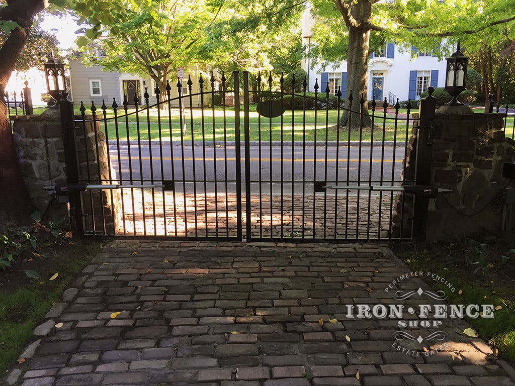 12ft Iron Driveway Gate with Automation Mounted on Posts  Behind Stone Columns