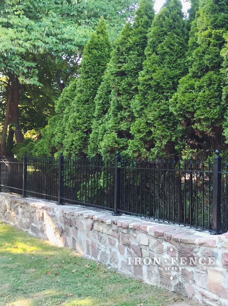 3ft Iron Fence Installed on a Stone Wall Top with Flange Posts