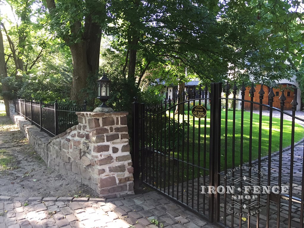 12ft Iron Driveway Gate Mounted on Posts  Behind Stone Columns