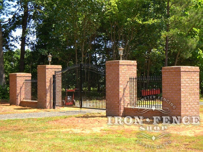 iron and brick fence wall attached to iron gate