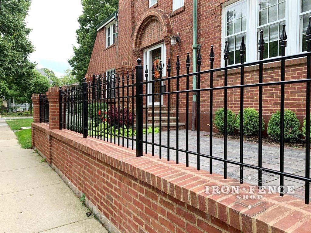 A custom 3ft tall iron fence core-drilled and wall-mounted