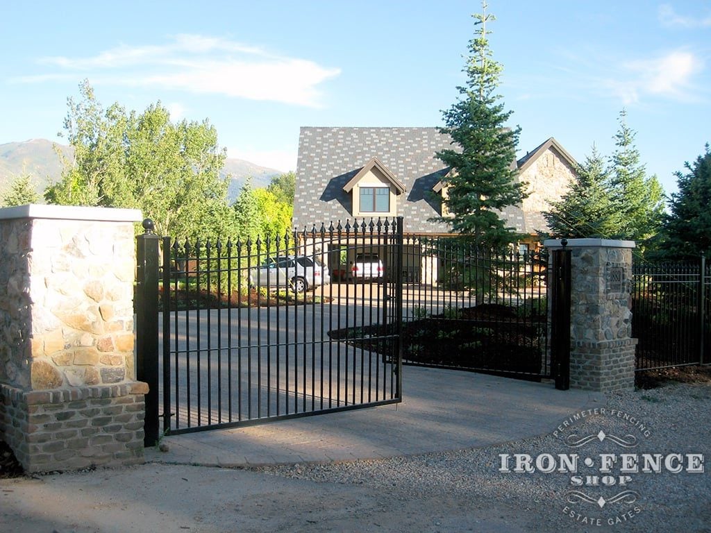 wide iron driveway double gates with decorative columns