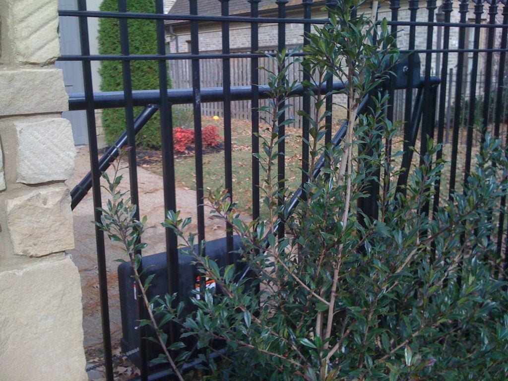 driveway gate with stone pillars