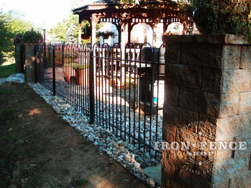 4 foot tall hoop and picket style iron fence with stone column