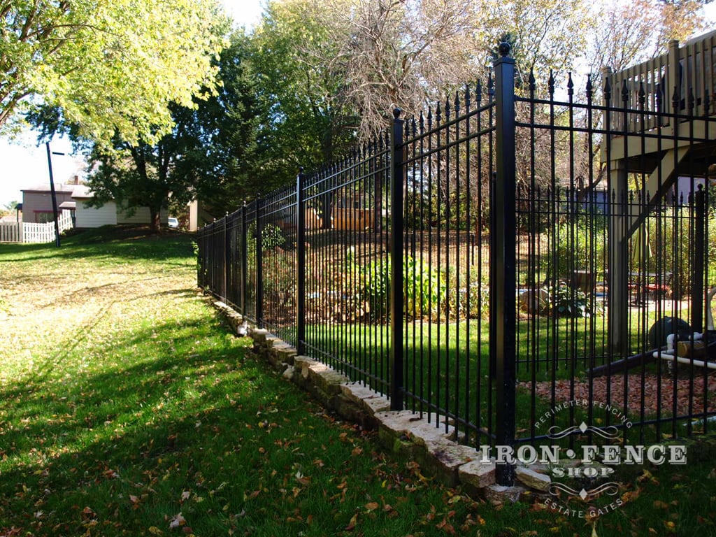 6ft Tall Traditional Grade Iron Fence - Installed with Decorative Stones Underneath and Stair-Stepped to Beautifully Follow the Slope of the Yard Grade (Style #1: Classic)