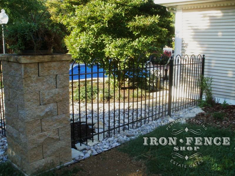 4ft Iron Hoop and Picket style fence surrounding a pool and connecting to stone columns